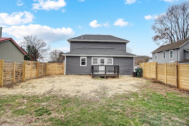 back of house with a deck