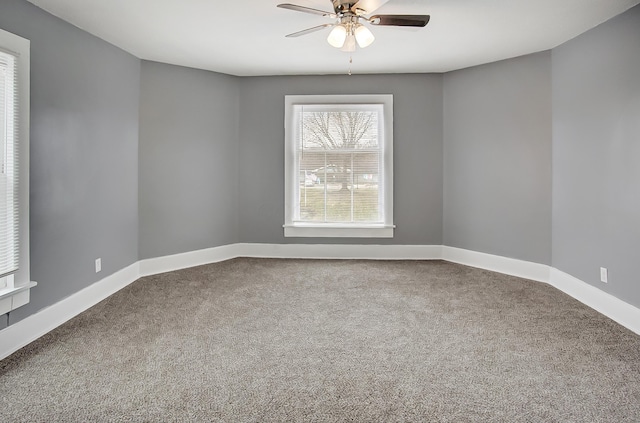 empty room featuring carpet flooring and ceiling fan