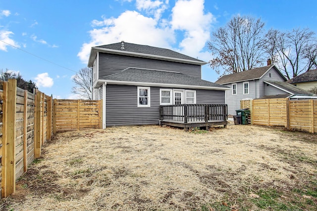 rear view of property featuring a deck