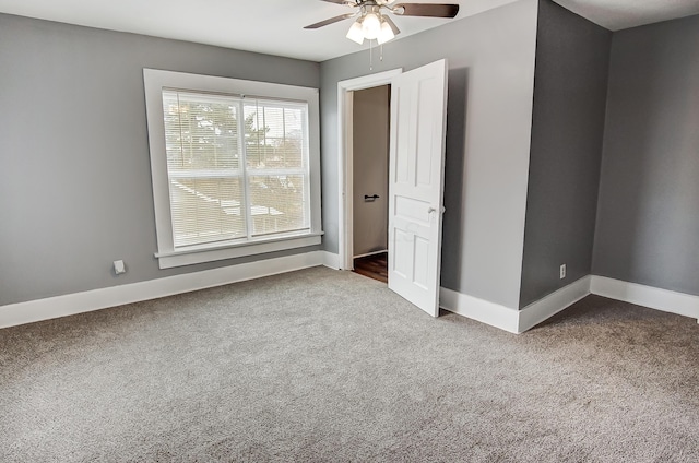 unfurnished bedroom featuring ceiling fan and carpet