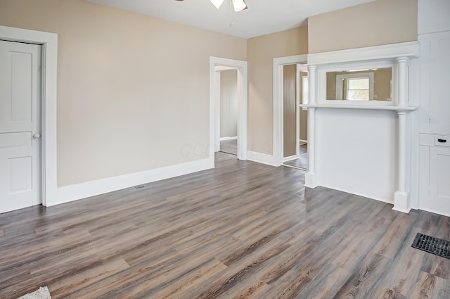 unfurnished living room with ceiling fan and dark hardwood / wood-style flooring