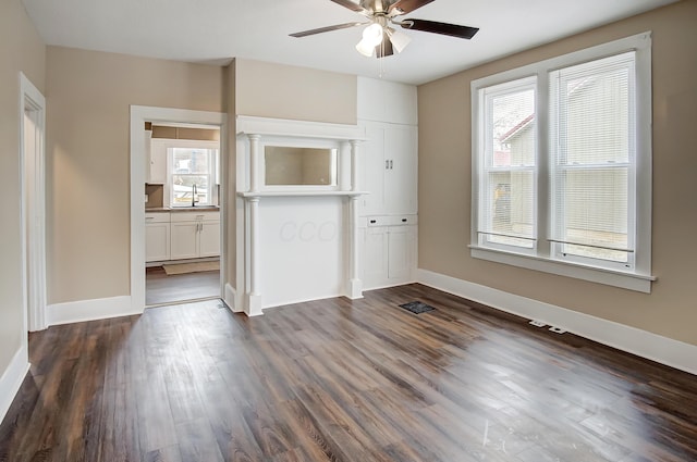 interior space featuring dark hardwood / wood-style flooring, sink, and ceiling fan