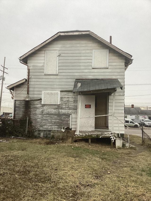 back of property featuring a lawn