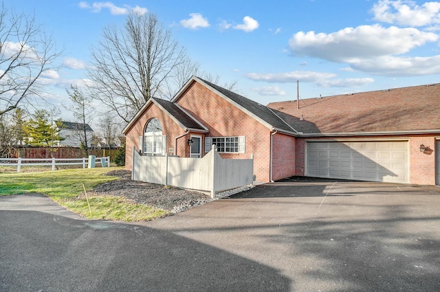 view of home's exterior with a garage and a yard