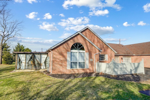 view of property exterior featuring a yard and a sunroom