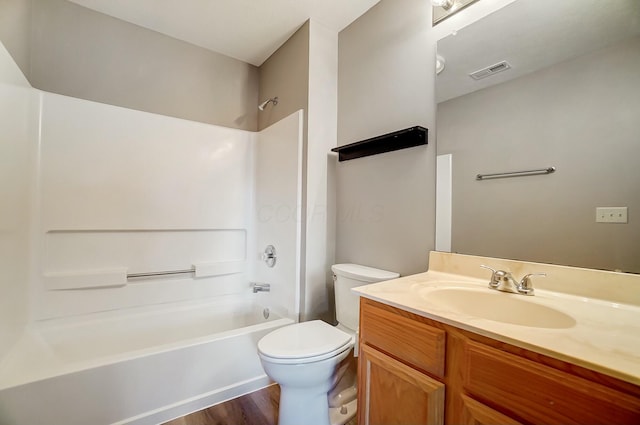 full bathroom with toilet, hardwood / wood-style floors, vanity, and shower / bathing tub combination