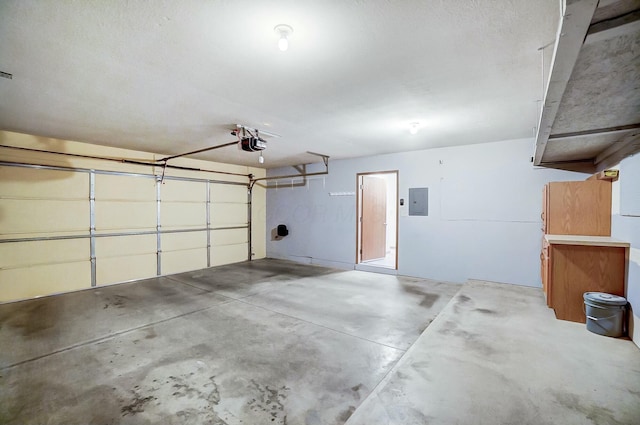 garage with a garage door opener and electric panel