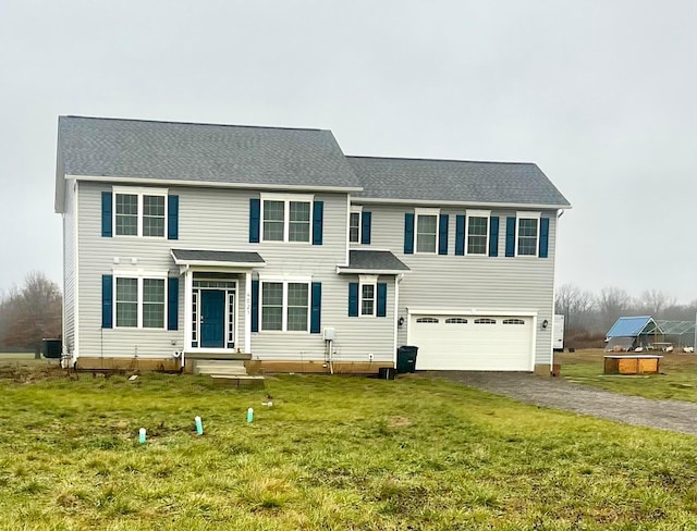 view of front of home featuring a garage, a front lawn, and central air condition unit