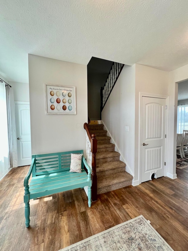 4021 County Road 124, Cardington, OH 43315 - stairs featuring a textured ceiling, baseboards, and wood finished floors