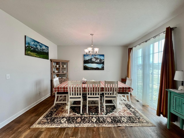 4021 County Road 124, Cardington, OH 43315 - dining area featuring baseboards, a notable chandelier, wood finished floors, and a textured ceiling