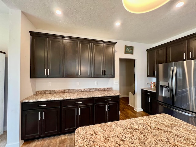 4021 County Road 124, Cardington, OH 43315 - kitchen featuring stainless steel fridge with ice dispenser, dark brown cabinetry, wood finished floors, and a textured ceiling