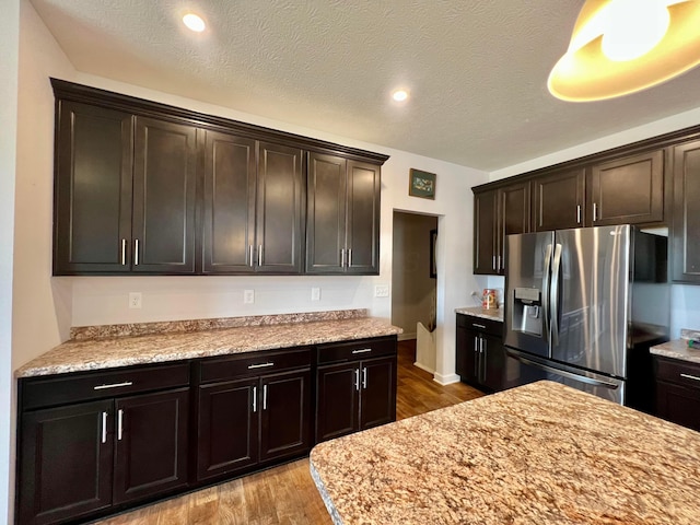 4021 County Road 124, Cardington, OH 43315 - kitchen featuring dark brown cabinetry, a textured ceiling, wood finished floors, and stainless steel refrigerator with ice dispenser
