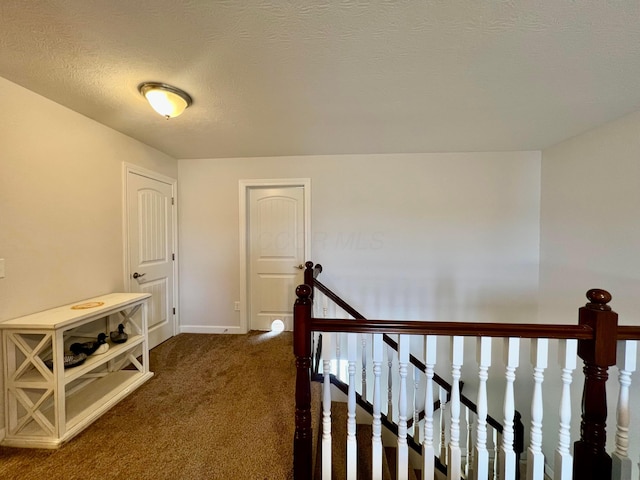 4021 County Road 124, Cardington, OH 43315 - hall with an upstairs landing, baseboards, dark carpet, and a textured ceiling