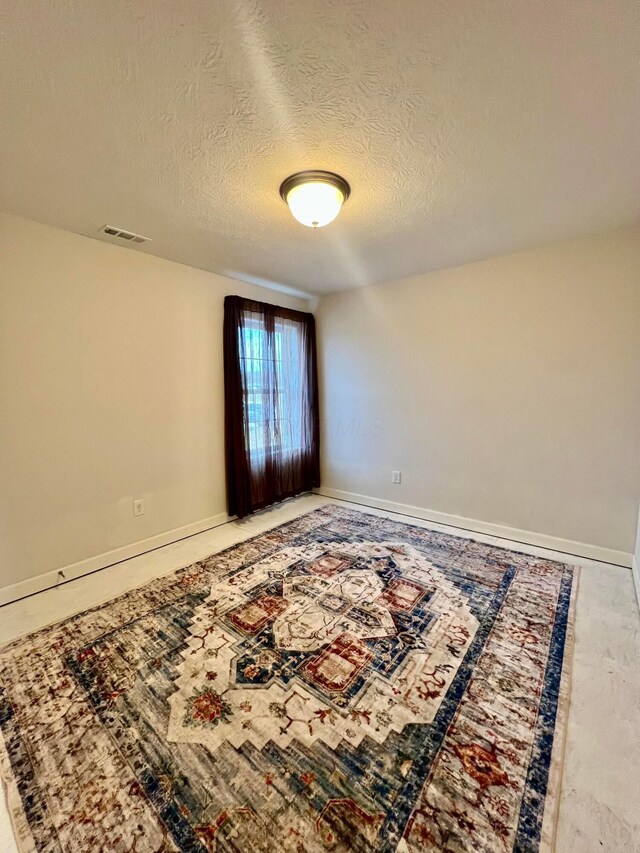 4021 County Road 124, Cardington, OH 43315 - spare room featuring a textured ceiling, baseboards, and visible vents