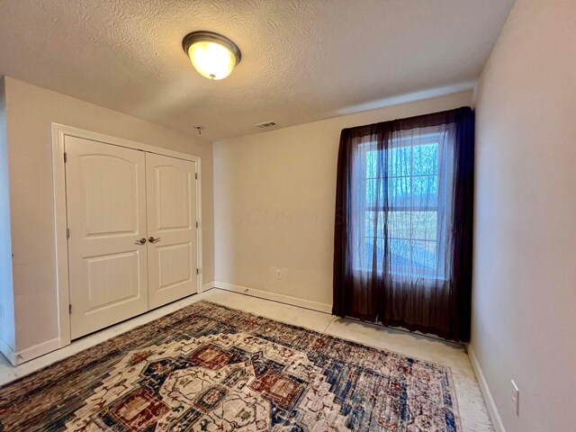 4021 County Road 124, Cardington, OH 43315 - interior space featuring baseboards, a textured ceiling, and visible vents
