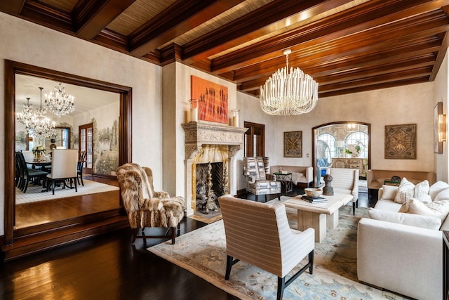 living room with beamed ceiling, a high end fireplace, wood-type flooring, and a notable chandelier