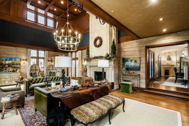 living room with an inviting chandelier, wood-type flooring, beamed ceiling, and a high ceiling