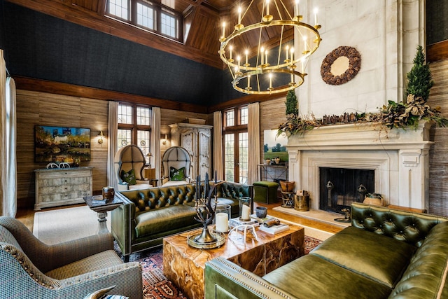 living room with an inviting chandelier, a towering ceiling, a fireplace, and wooden walls