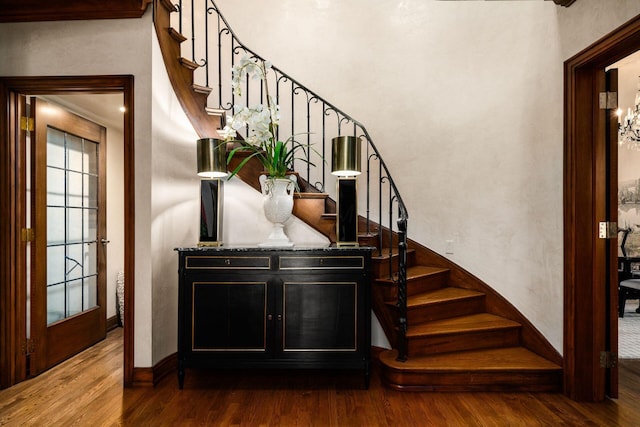 stairs featuring hardwood / wood-style floors