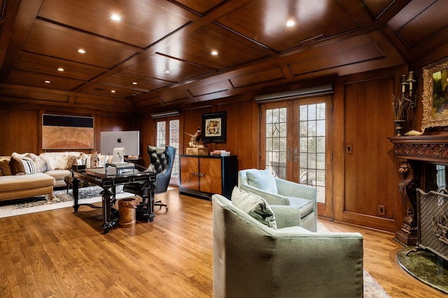 living room with coffered ceiling, wooden ceiling, french doors, and wood walls