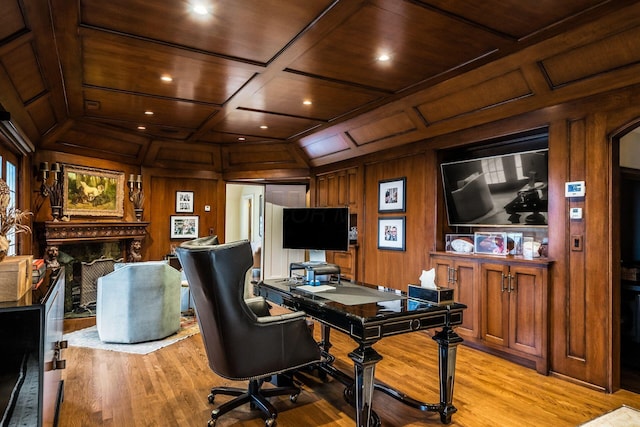 office area with wood ceiling, coffered ceiling, and wooden walls