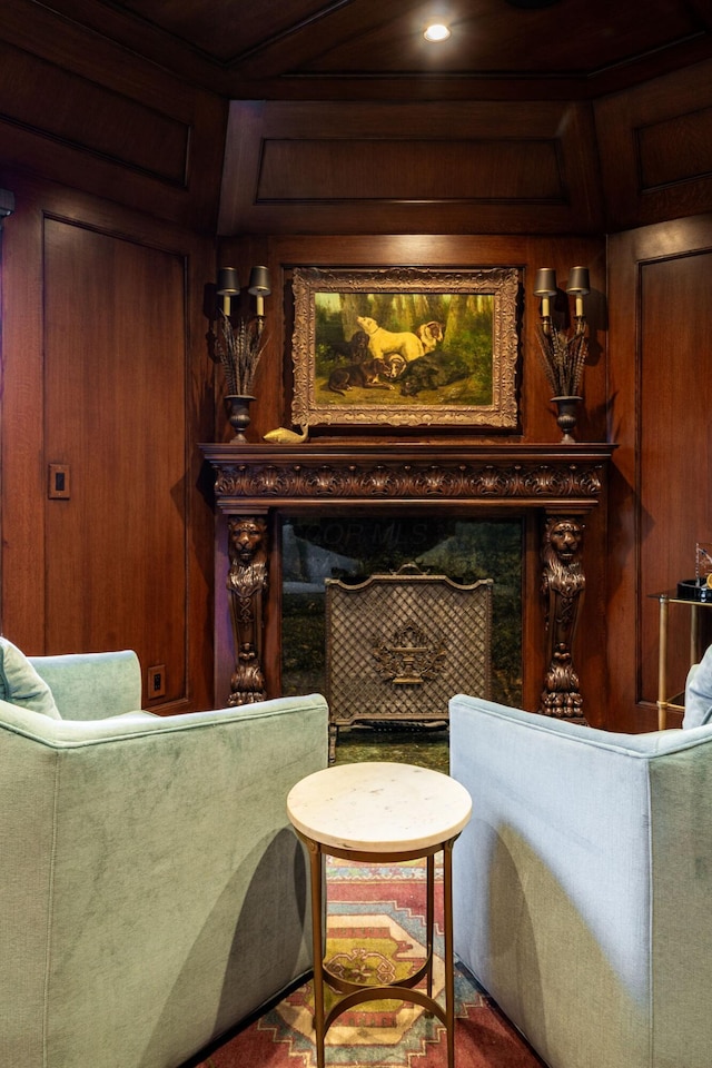 living area featuring a premium fireplace and wooden walls