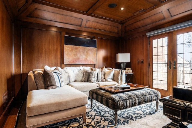 home theater with coffered ceiling, wooden ceiling, wooden walls, and french doors