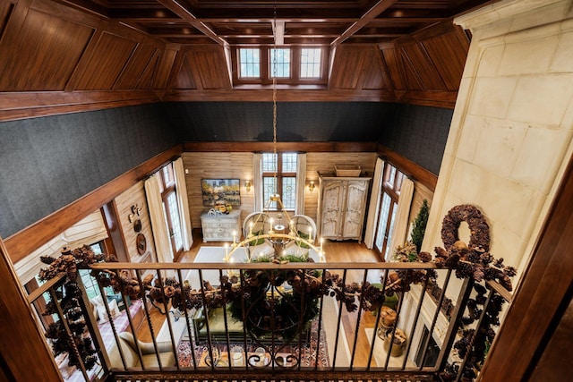 room details with a notable chandelier and wood walls