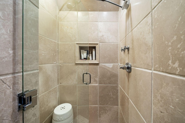 bathroom with a shower with door