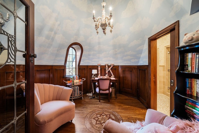 sitting room featuring wood-type flooring and an inviting chandelier