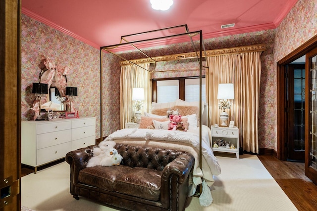 bedroom featuring crown molding and hardwood / wood-style flooring