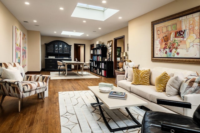 living room featuring hardwood / wood-style flooring and a skylight