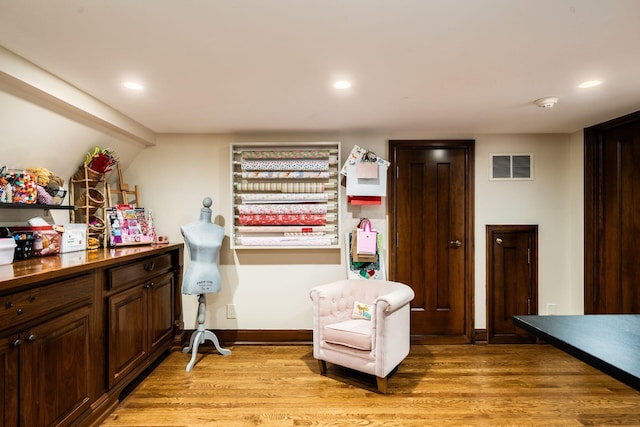 living area with light hardwood / wood-style flooring