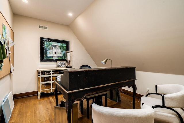 sitting room featuring lofted ceiling and hardwood / wood-style flooring