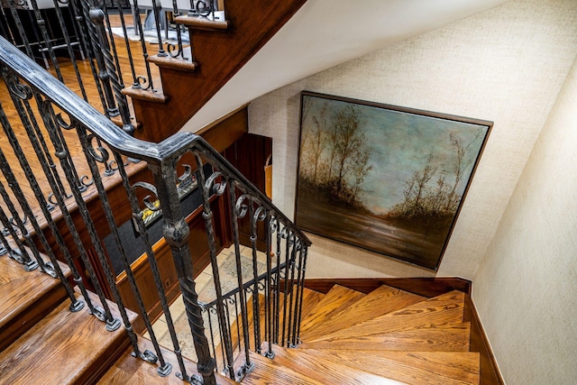 staircase with lofted ceiling