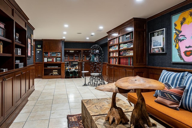 sitting room featuring light tile patterned flooring and crown molding