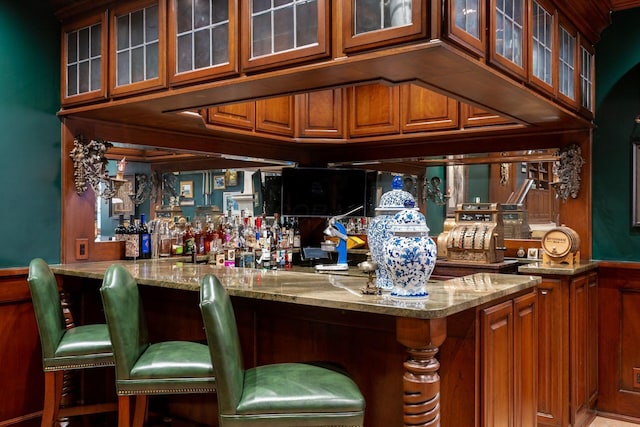 bar featuring light stone countertops