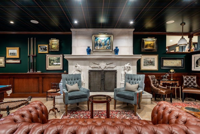 sitting room featuring crown molding and a fireplace