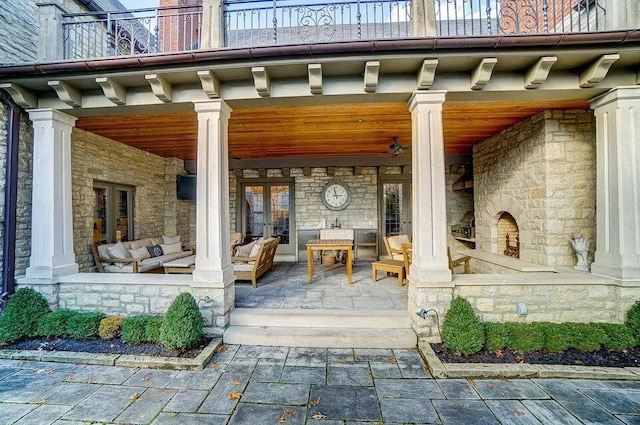 view of patio / terrace featuring a balcony and an outdoor living space with a fireplace