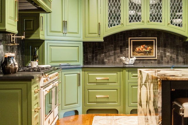 bar featuring decorative backsplash, high end white range, and green cabinets