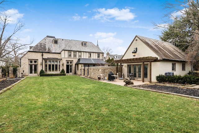 back of property featuring a lawn and a patio