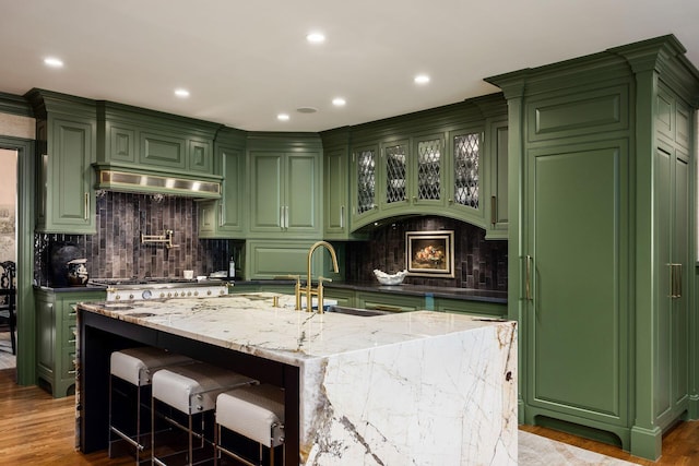 2528 Tremont Rd, Columbus, OH 43221 - kitchen with green cabinets, a sink, under cabinet range hood, and recessed lighting