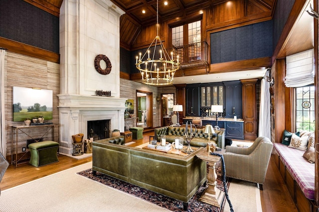 2528 Tremont Rd, Columbus, OH 43221 - living area with a towering ceiling, a fireplace with raised hearth, a chandelier, wood finished floors, and coffered ceiling