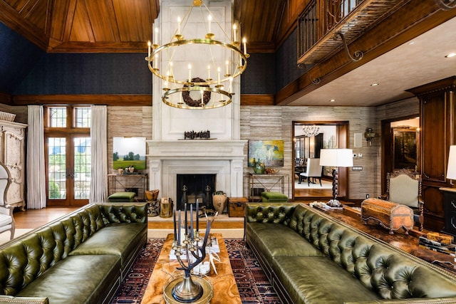 2528 Tremont Rd, Columbus, OH 43221 - living area featuring a high ceiling, a chandelier, a fireplace with raised hearth, and french doors