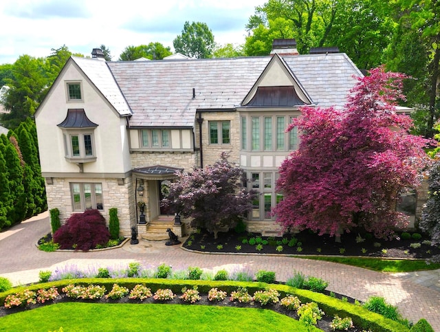 2528 Tremont Rd, Columbus, OH 43221 - tudor home with stone siding, stucco siding, a standing seam roof, and a chimney