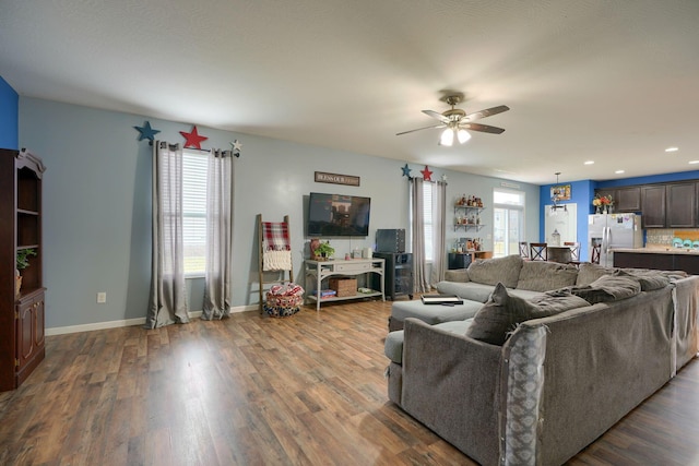 living room with ceiling fan and hardwood / wood-style floors