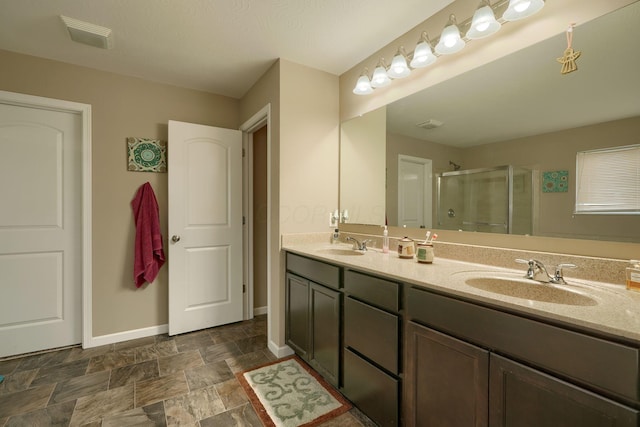 bathroom featuring vanity and a shower with shower door