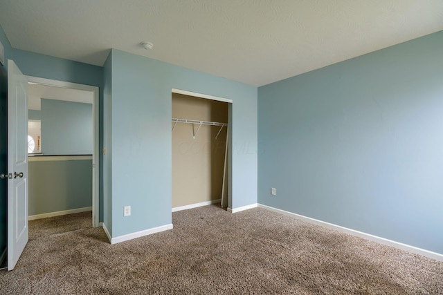 unfurnished bedroom with a closet and carpet