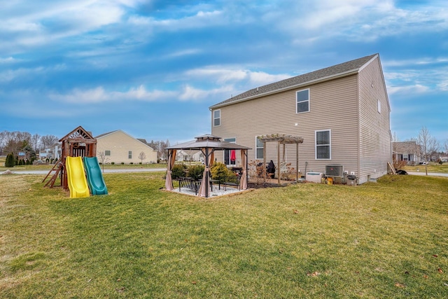 back of property with a playground, a gazebo, a lawn, and central air condition unit