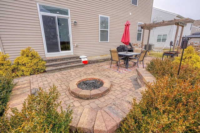 view of patio featuring central AC unit, a pergola, and an outdoor fire pit